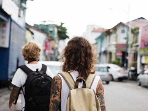 Backpackers walking through a city during an independent budget travel journey
