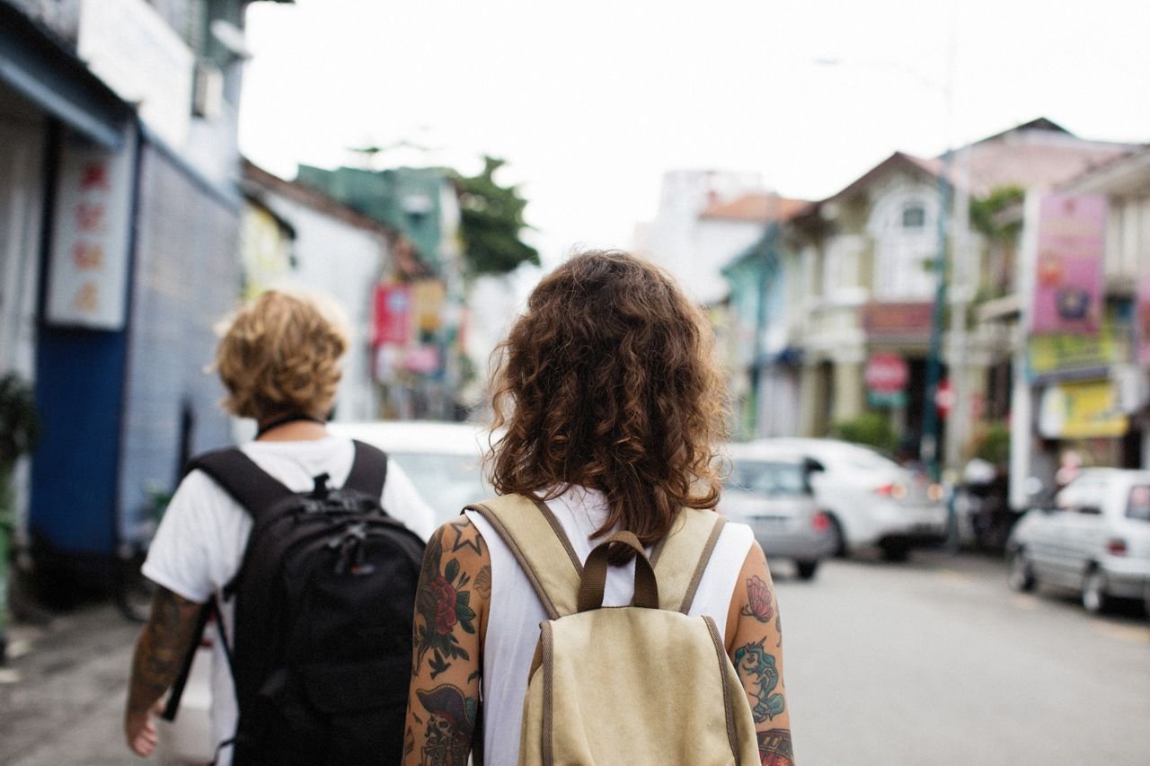 Backpackers walking through a city during an independent budget travel journey
