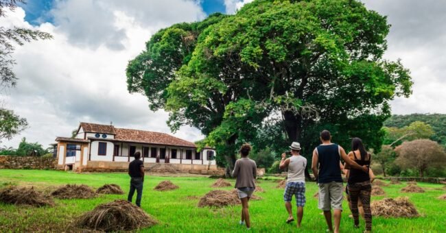 Group walking through a green rural landscape, illustrating ecovillage community living
