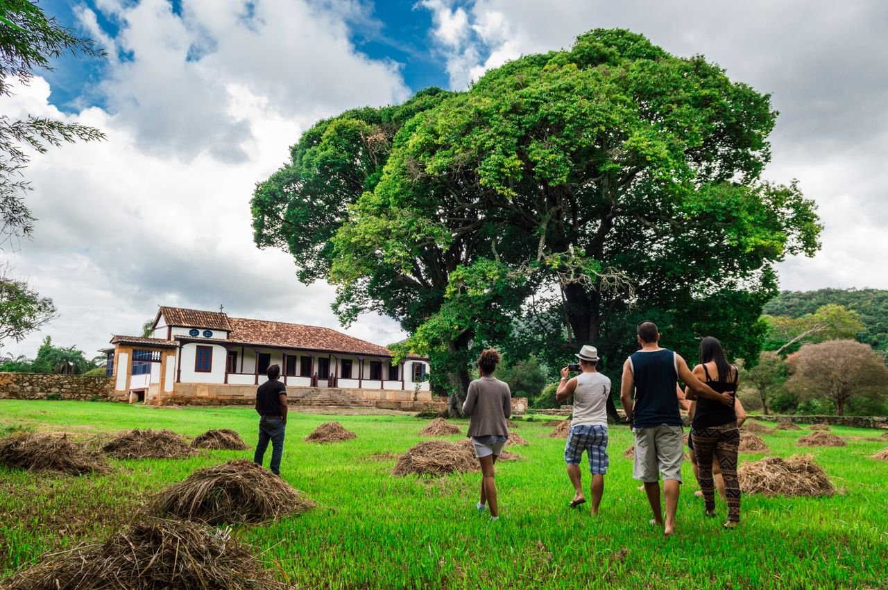 Group walking through a green rural landscape, illustrating ecovillage community living