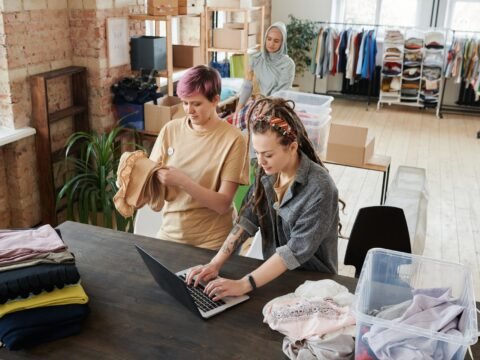 Volunteers organizing donations for a small nonprofit fundraising project
