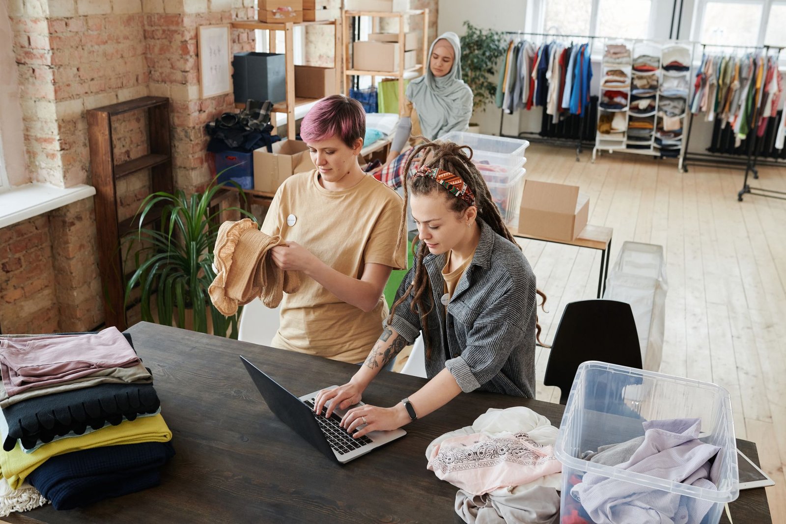 Volunteers organizing donations for a small nonprofit fundraising project