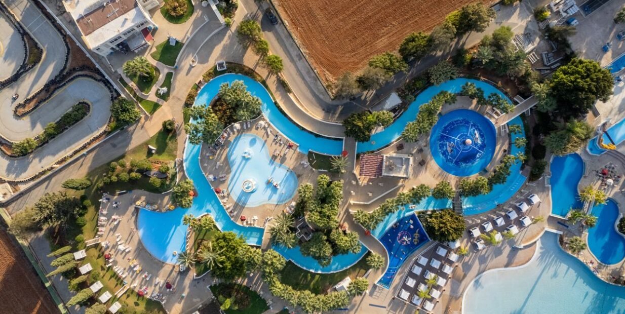 Ayia Napa resort pool seen from above in Cyprus, illustrating a seasonal kids entertainer job