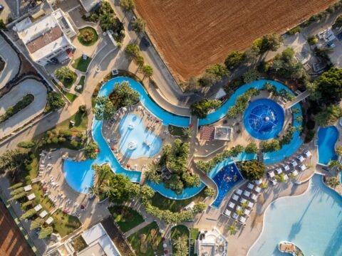 Ayia Napa resort pool seen from above in Cyprus, illustrating a seasonal kids entertainer job