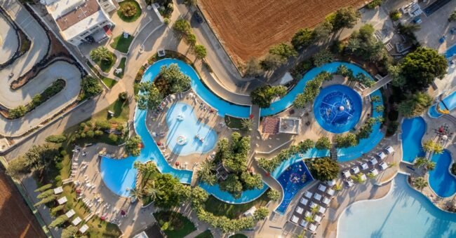 Ayia Napa resort pool seen from above in Cyprus, illustrating a seasonal kids entertainer job