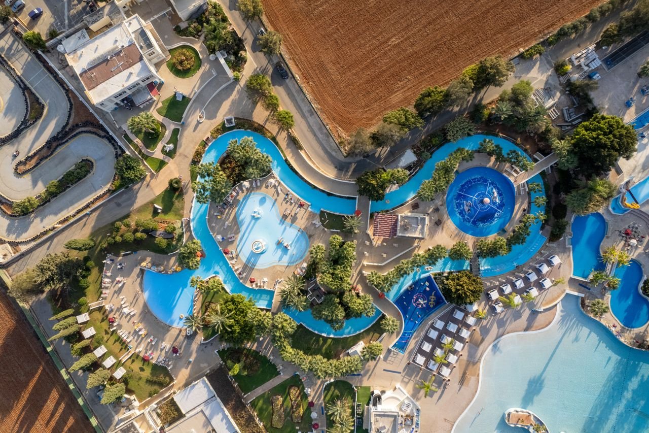Ayia Napa resort pool seen from above in Cyprus, illustrating a seasonal kids entertainer job