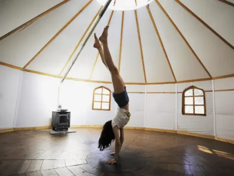 Aletheia retreat center in Andalusia, Spain, with a woman practising movement inside the large yurt