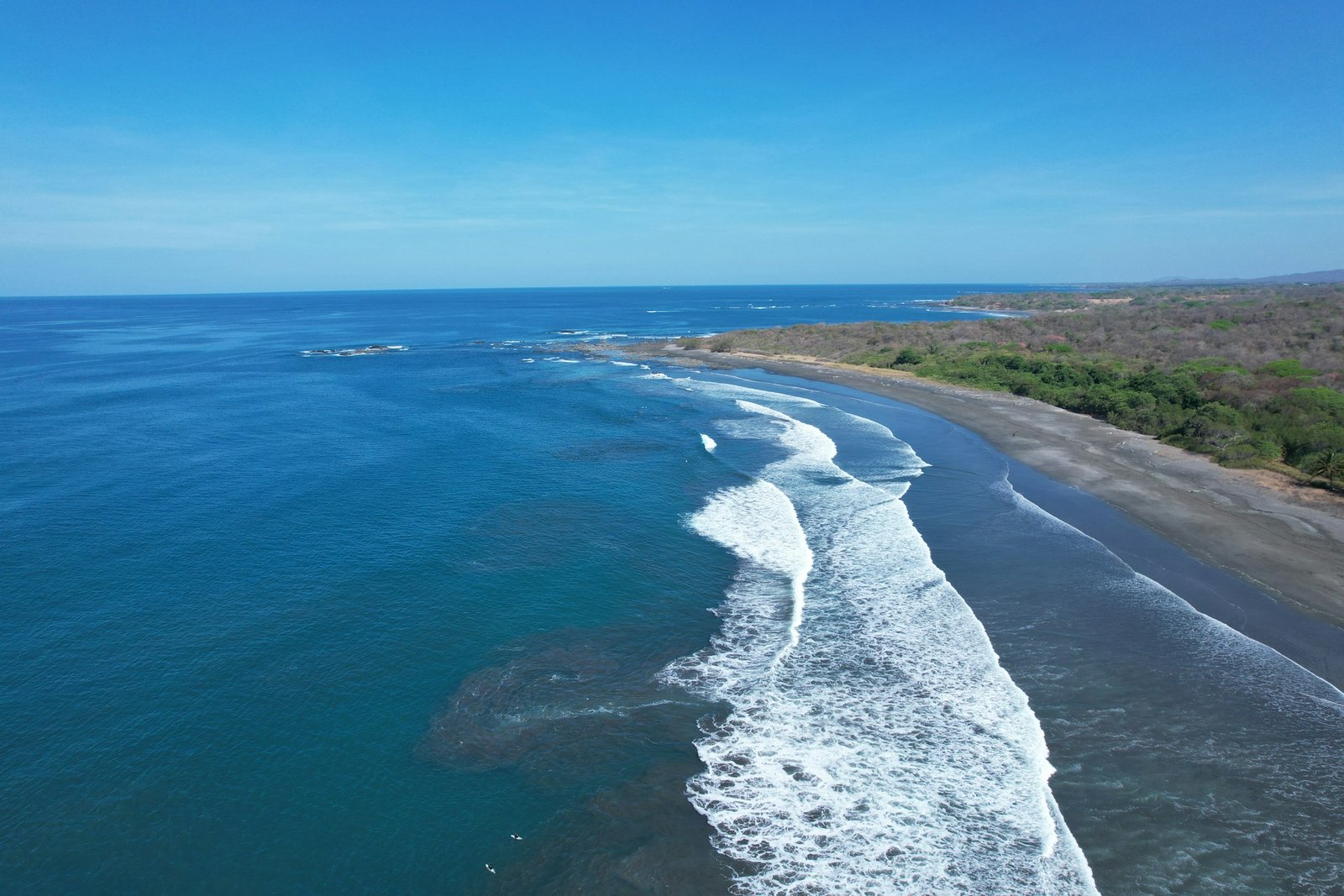 Aerial view of the Pacific coastline near Marbella, Guanacaste, Costa Rica, with waves breaking along the beach.